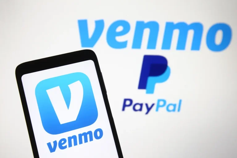Venmo logo, a mobile payment service of PayPal is seen displayed on a smartphone and a PC screen.