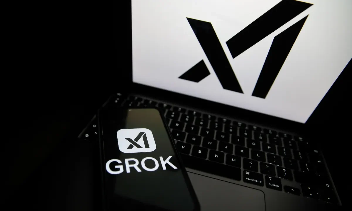 The Grok logo appears on a phone and the xAI logo is displayed on a laptop.