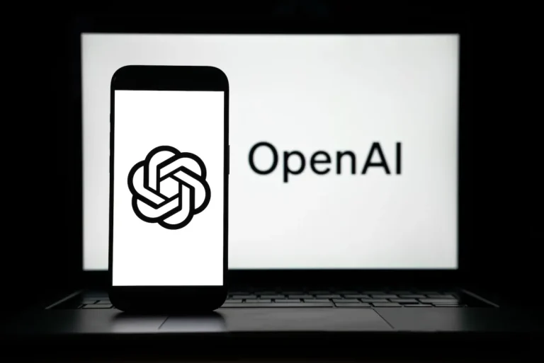 the logos of Open AI displayed on both computer and smart phone screen