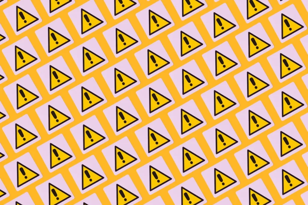 yellow warning symbols with exclamation points on a patterned background