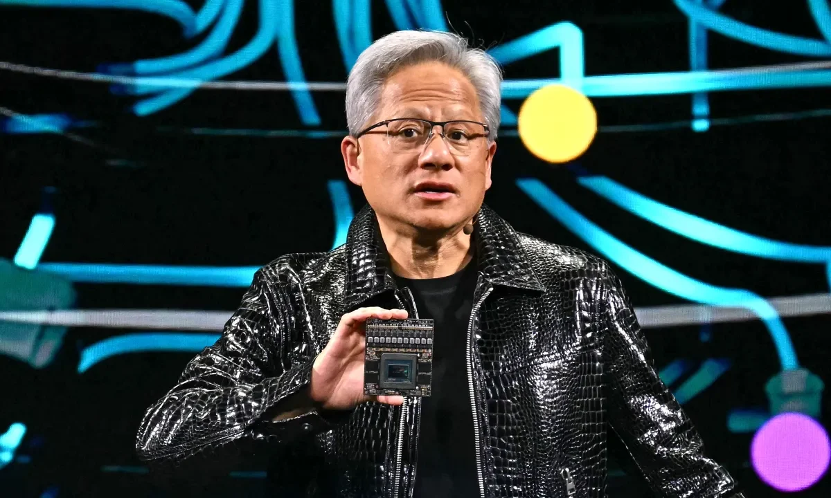 Jensen Huang holds up chip at CES 2025