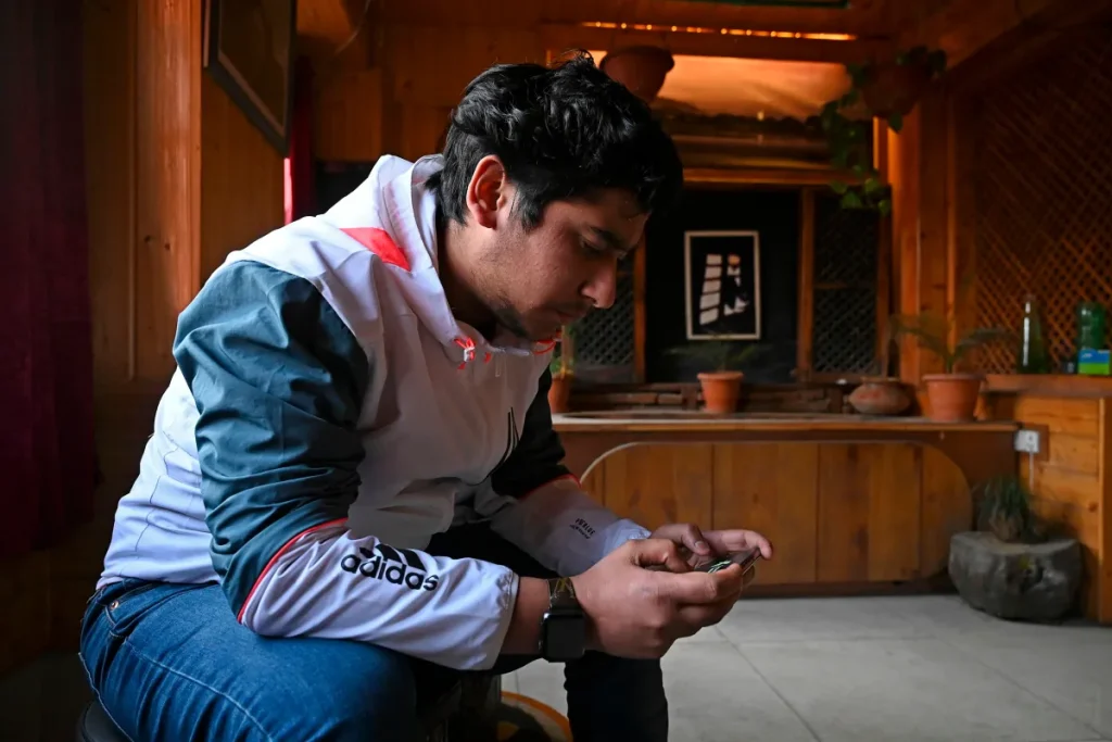 seated man looking at ell phone