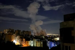 A smoke plume rises following a missile strike on a building in Tehran on March 1, 2026.