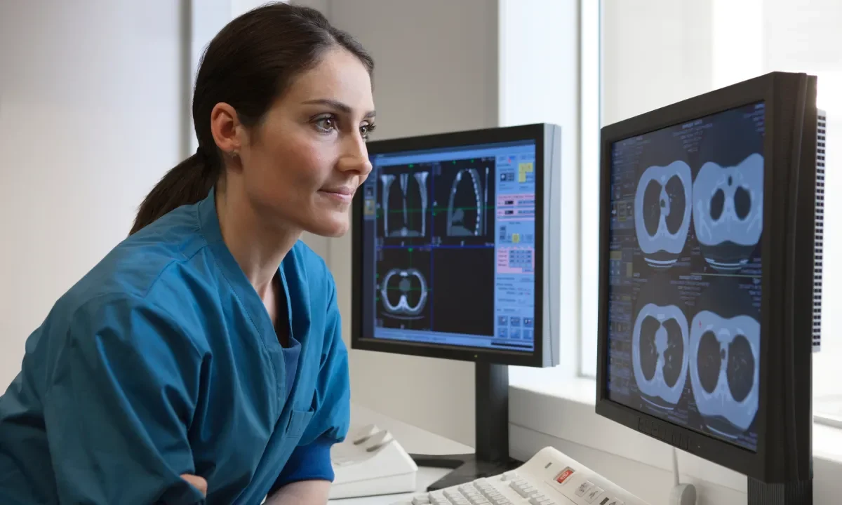 Doctor looking at x-rays from CT-scanner on computer