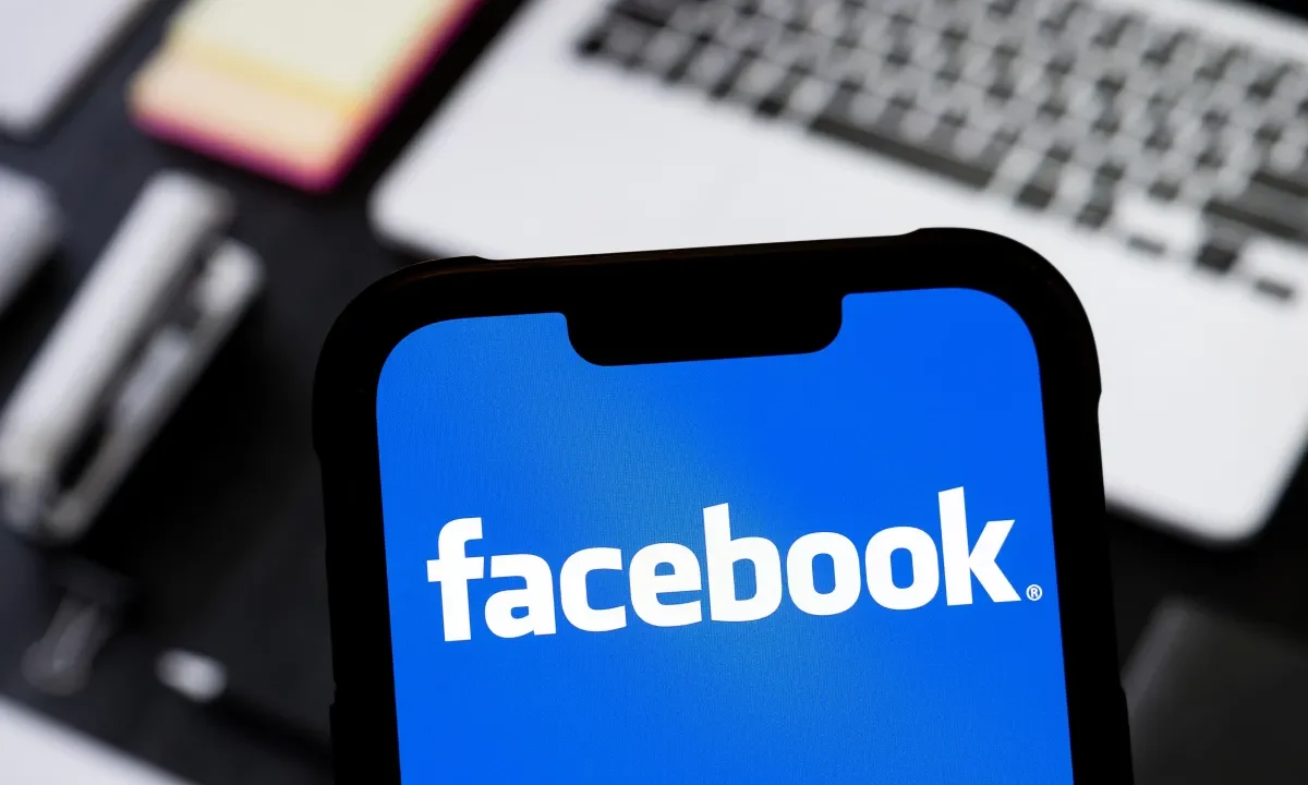 photo illustration of Facebook logo is seen displayed on a smartphone.
