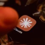 The Claude app icon is displayed on a smartphone screen