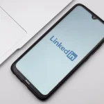 LinkedIn mobile app displayed on smartphone set on desk