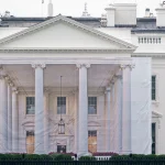 A protective tarp with a photo on it covers the scaffolding and the columns on the North Portico of the White House on July 18, 2026 in Washington, DC..