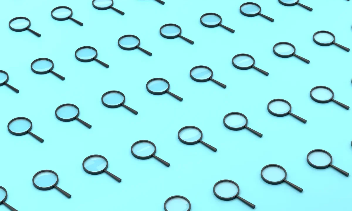Repeated Magnifying Glass On Blue Background