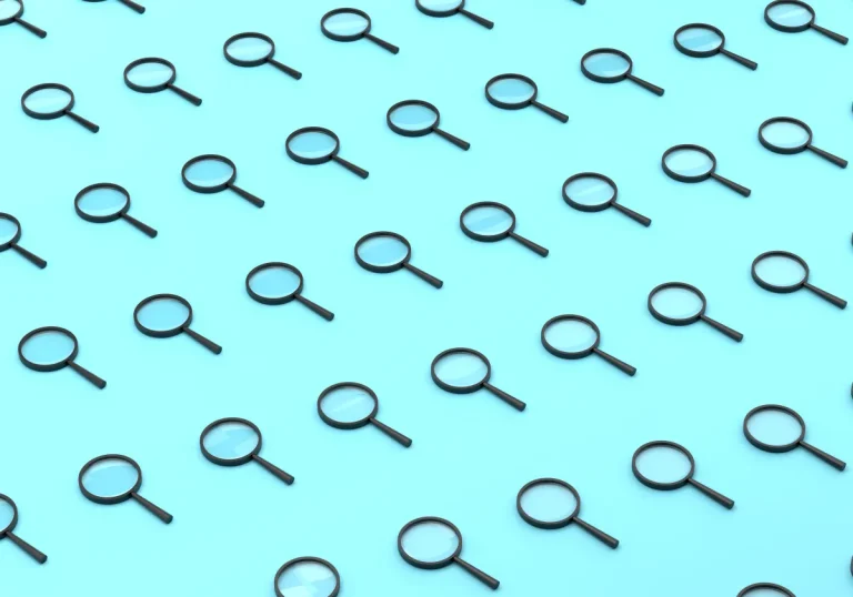 Repeated Magnifying Glass On Blue Background
