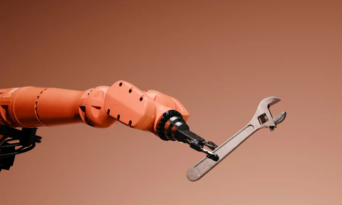 Conceptual image of a robotic arm holding a wrench.