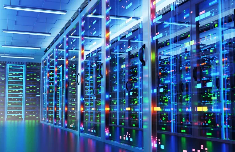 Modern data center with racks of cabinets and colored lights.
