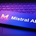 The Mistral AI logo appears on a smartphone screen in this photo illustration