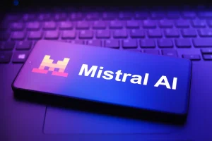 The Mistral AI logo appears on a smartphone screen in this photo illustration