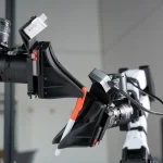 XDOF's robotic arms manipulate a pen and cap.