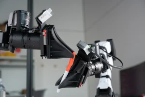XDOF's robotic arms manipulate a pen and cap.