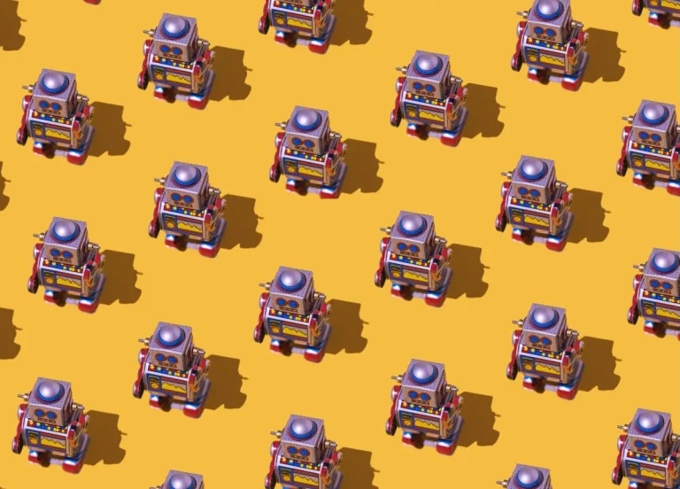 Pattern of retro tin toy robots with clocks and displays painted on yellow background.