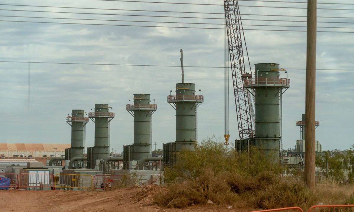 Five smoke stacks stand at a construction site in Texas.