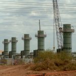 Five smoke stacks stand at a construction site in Texas.